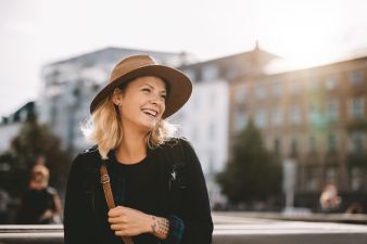 laughing mature blonde woman wearing a hat