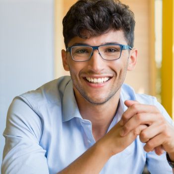 Young man wearing glasses Elegant Smiles patient care