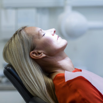Woman relaxing on dentist chair Elegant Smiles care