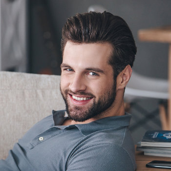 Smiling handsome businessman Elegant Smiles patient
