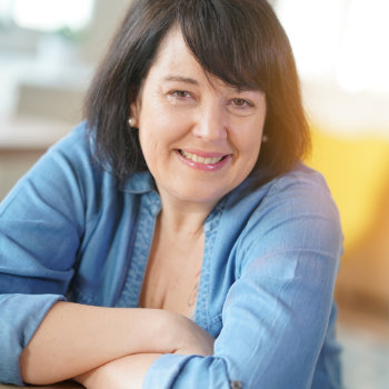 Mature brunette woman smiling Elegant Smiles care